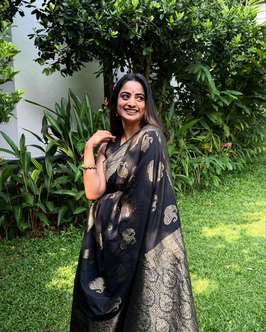 Draped in black, glowing in gold.