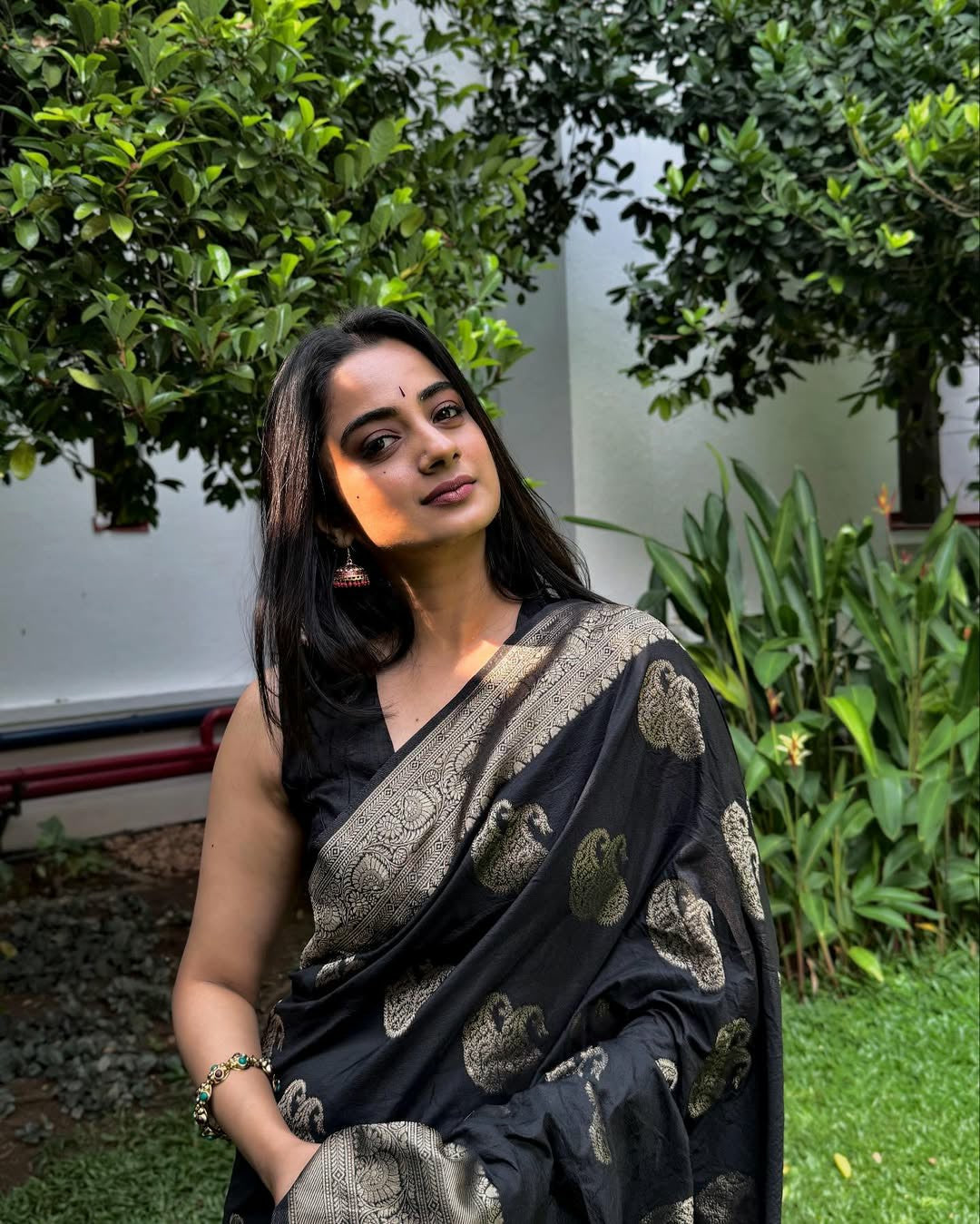 Draped in black, glowing in gold.