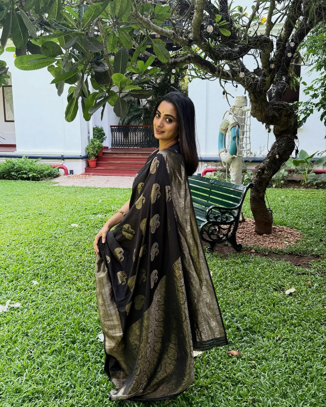 Draped in black, glowing in gold.